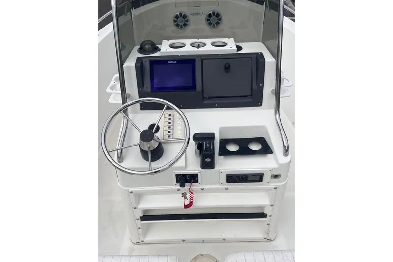 Slide: The Image of 1995 Wahoo 2100 EFS boat console with steering wheel and navigation controls. - 16