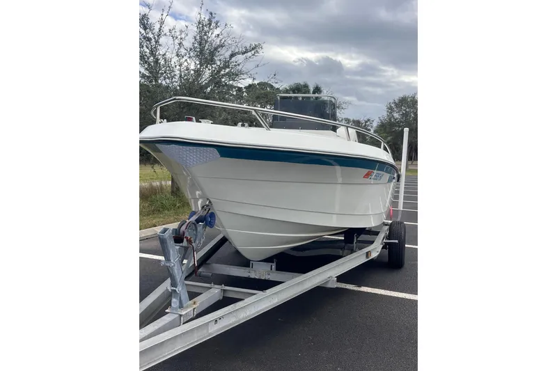 Slide: The Image of 1995 Wahoo 2100 EFS boat on trailer, parked outdoors, overcast sky. - 3