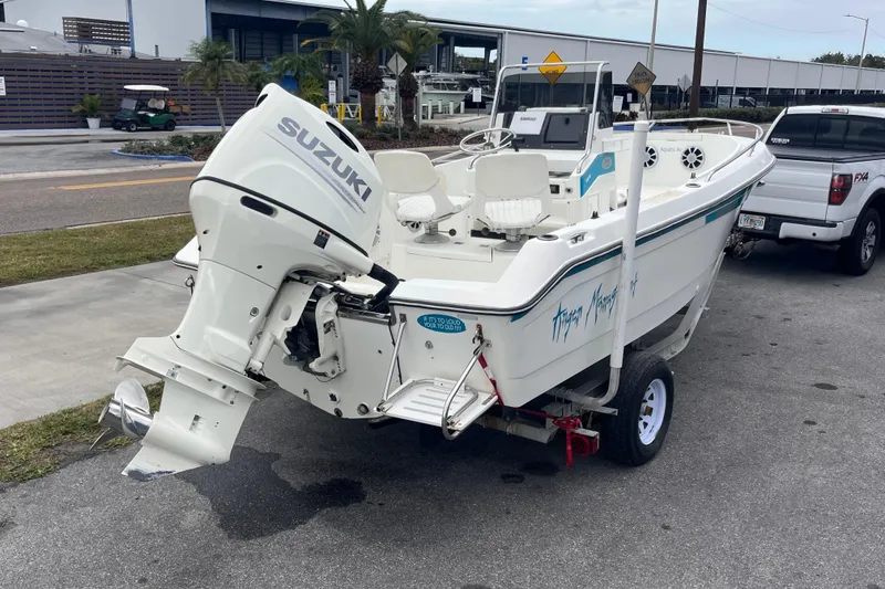 Slide: The Image of 1995 Wahoo 2100 EFS boat with Suzuki outboard motor on trailer. - 4
