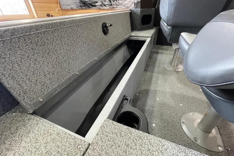 Slide: The Image of Interior of 2026 Lund 1700 Explorer Sport boat, featuring seating and storage compartments. - 10