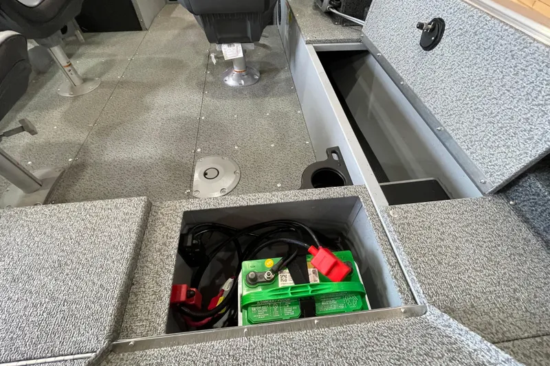 Slide: The Image of 2026 Lund 1700 Explorer Sport boat interior with battery compartment open. - 11