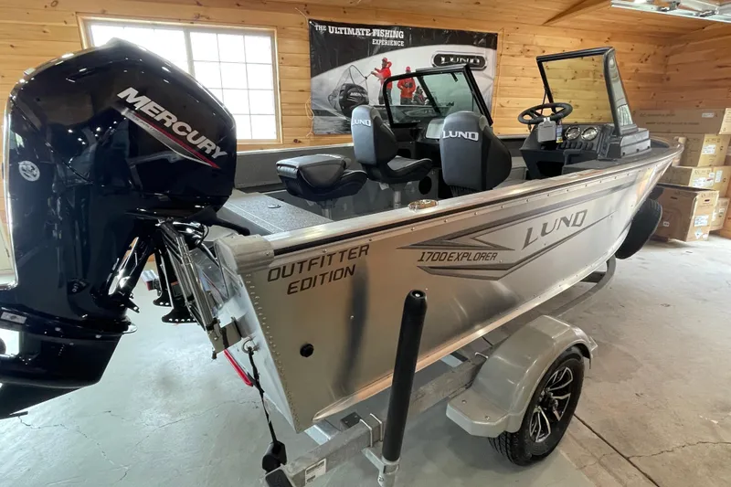 Slide: The Image of 2026 Lund 1700 Explorer Sport boat in garage, featuring Mercury engine and outfitter edition. - 3
