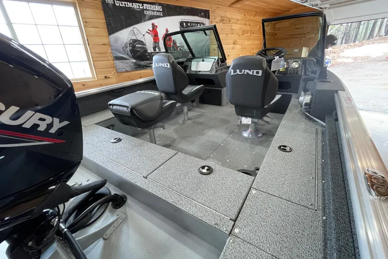 Slide: The Image of 2026 Lund 1700 Explorer Sport boat interior with Mercury engine, featuring comfortable seating and modern design. - 6