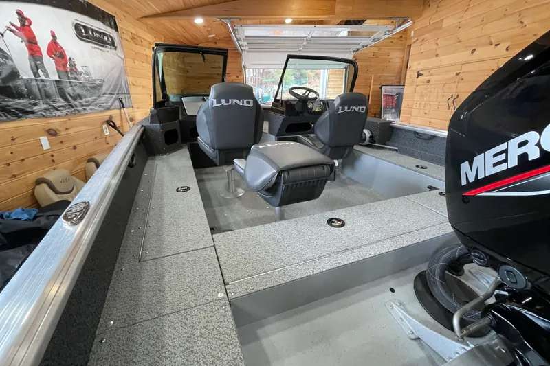 Slide: The Image of 2026 Lund 1700 Explorer Sport boat interior with Mercury engine in wooden garage. - 8