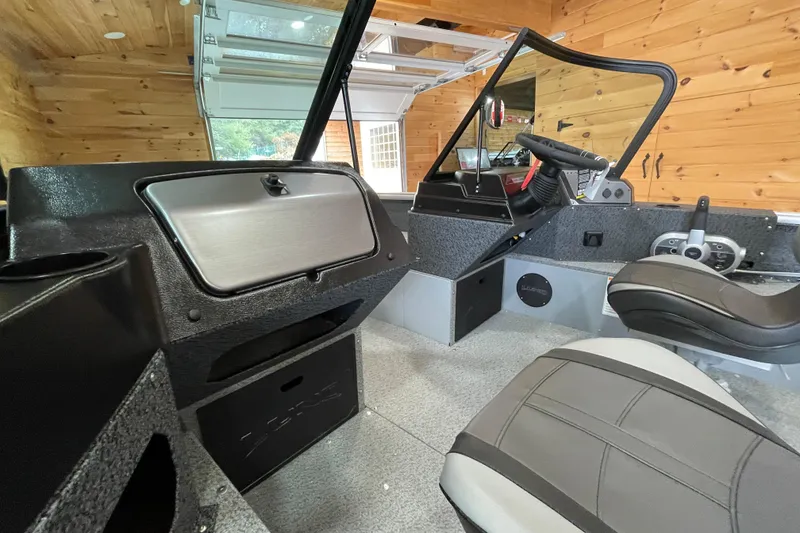 Slide: The Image of 2026 Lund 1700 Explorer Sport boat interior with modern dashboard and seating. - 9