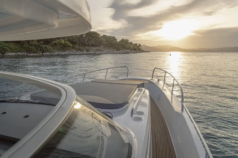 Slide: The Image of Nimbus Tender 11 yacht at sunset on calm waters, 2025 model. - 8