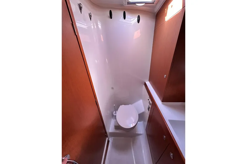 Slide: The Image of 2016 Beneteau Swift Trawler 34 helm with steering wheel and navigation controls. - 13