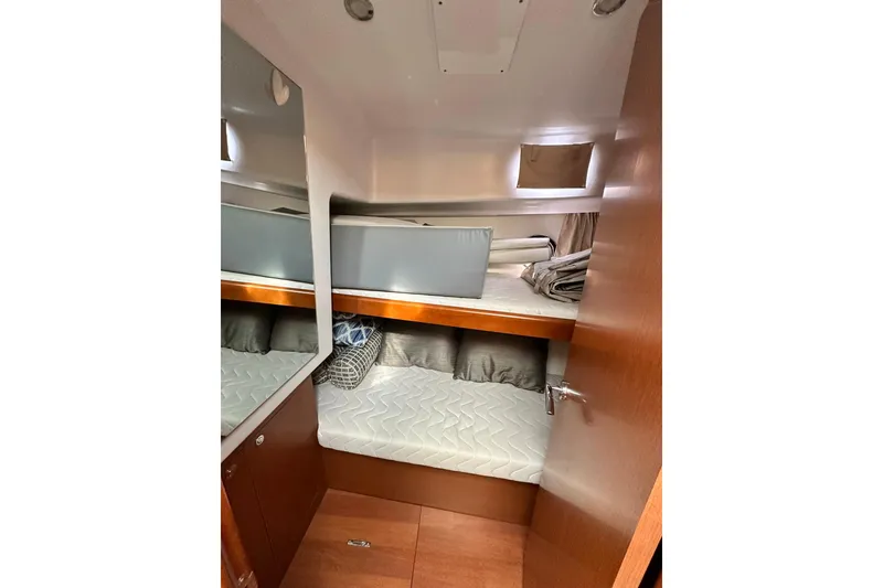 Slide: The Image of 2016 Beneteau Swift Trawler 34 docked, featuring covered equipment and seating area. - 14