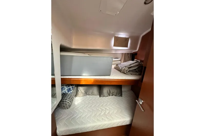 Slide: The Image of 2016 Beneteau Swift Trawler 34 flybridge with seating and table, docked at marina. - 15