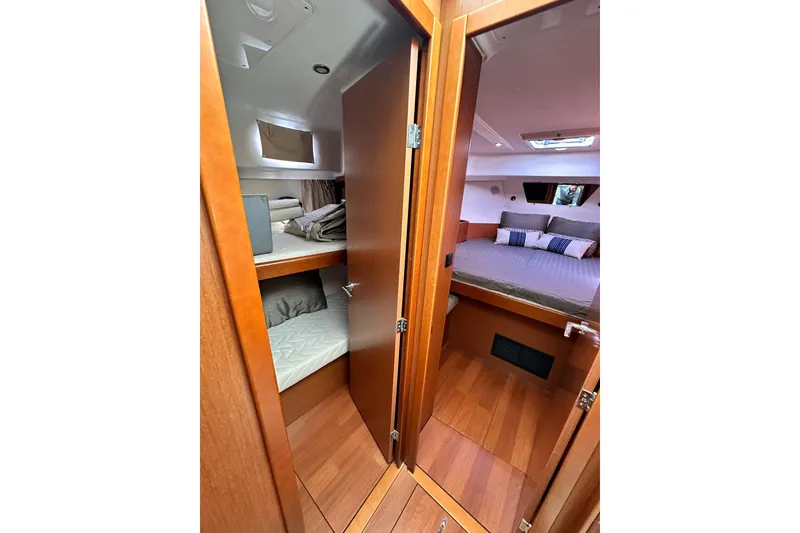 Slide: The Image of 2016 Beneteau Swift Trawler 34 deck with table, marina view in background. - 17
