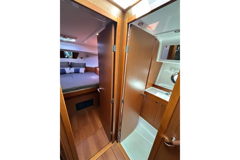 Slide: The Image of 2016 Beneteau Swift Trawler 34 flybridge with seating, table, and marina view. - 18