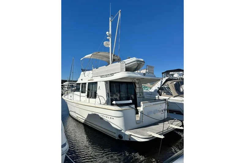 Slide: The Image of 2016 Beneteau Swift Trawler 34 docked, showcasing sleek design and spacious deck. - 3