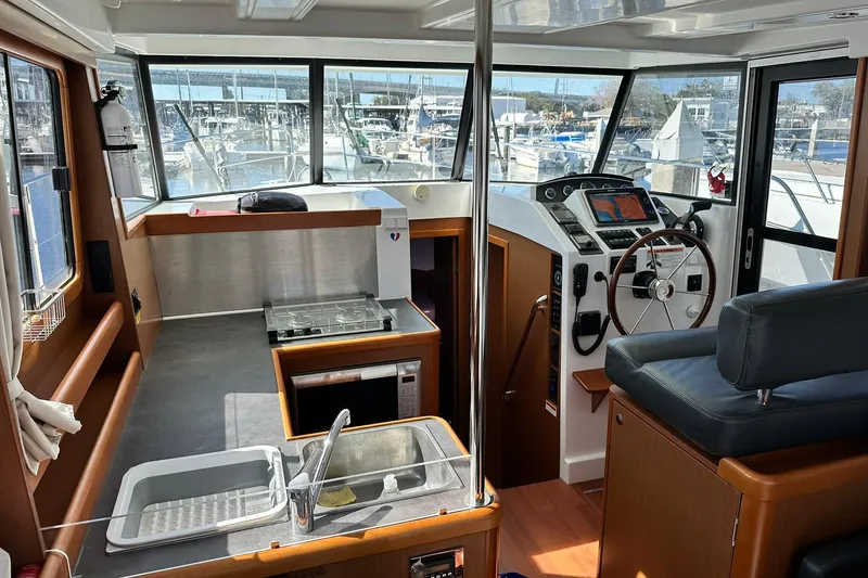 Slide: The Image of 2016 Beneteau Swift Trawler 34 cabin with bunk beds and porthole window. - 34