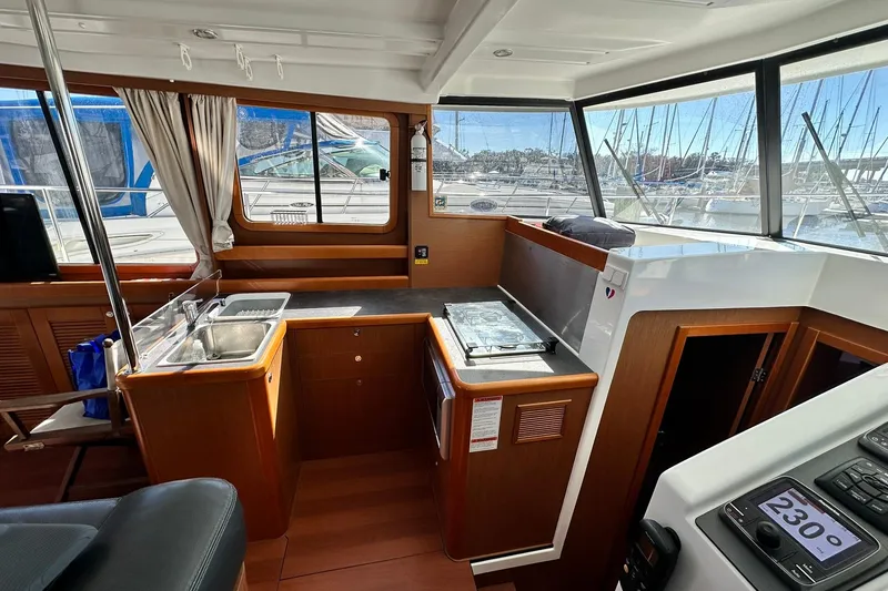 Slide: The Image of Interior of 2016 Beneteau Swift Trawler 34 with kitchen and navigation area. - 44