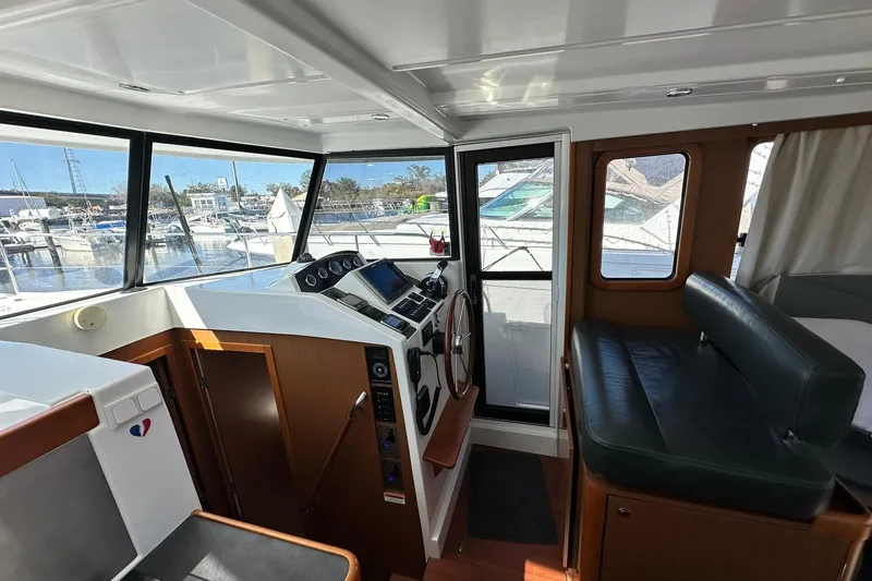 Slide: The Image of Interior of 2016 Beneteau Swift Trawler 34, featuring helm and seating area. - 45
