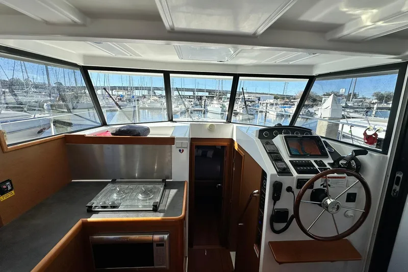 Slide: The Image of 2016 Beneteau Swift Trawler 34 interior with helm, navigation equipment, and galley. - 46