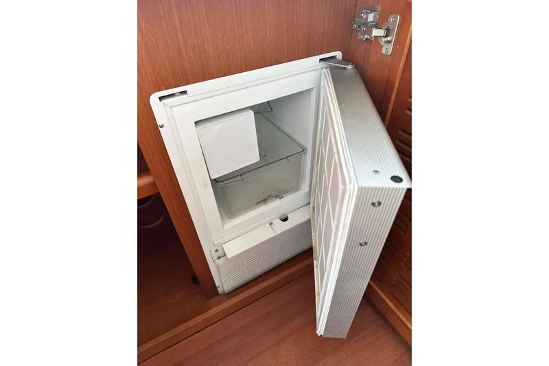 Slide: The Image of Open refrigerator in 2016 Beneteau Swift Trawler 34, showcasing interior storage space. - 50