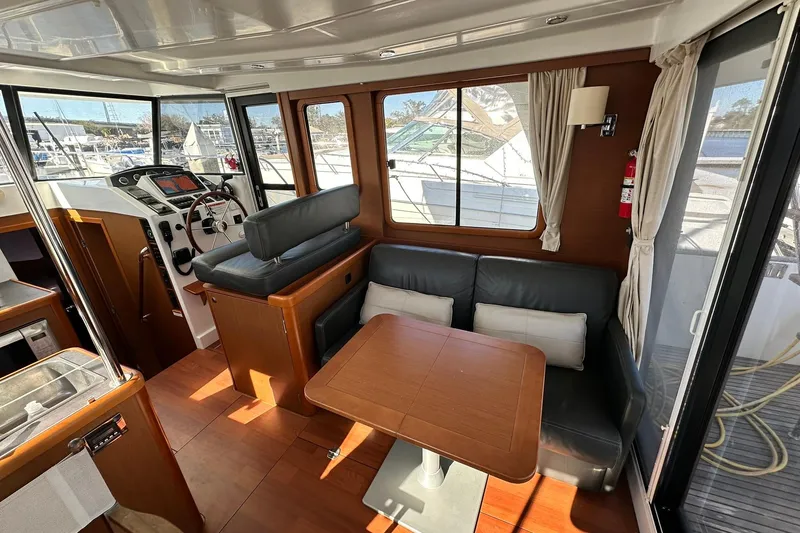 Slide: The Image of 2016 Beneteau Swift Trawler 34 interior with helm, seating, and dining area. - 54