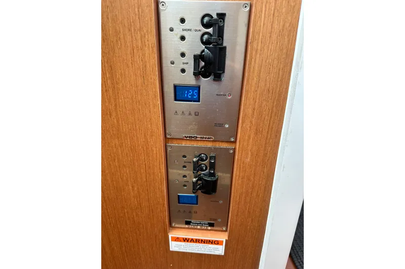 Slide: The Image of Control panel on 2016 Beneteau Swift Trawler 34, featuring switches and digital displays. - 59