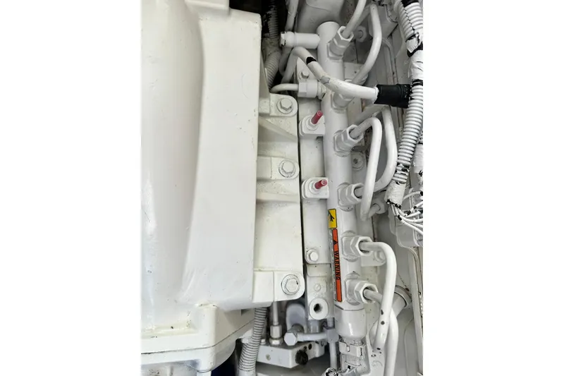 Slide: The Image of Engine components of a 2016 Beneteau Swift Trawler 34, showcasing intricate piping and connections. - 61
