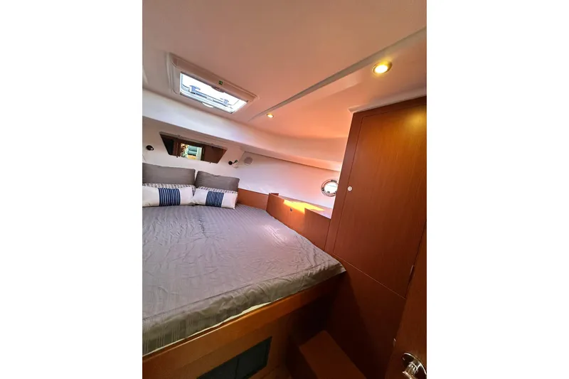 Slide: The Image of 2016 Beneteau Swift Trawler 34 docked, showcasing spacious deck and flybridge. - 7