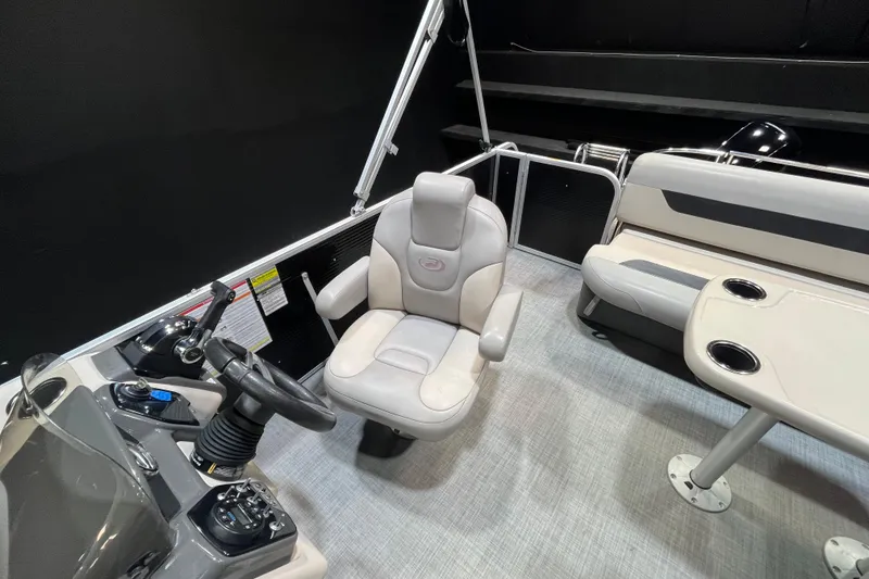 Slide: The Image of 2023 Princecraft Vectra 23 boat interior with helm, seating, and table. - 11