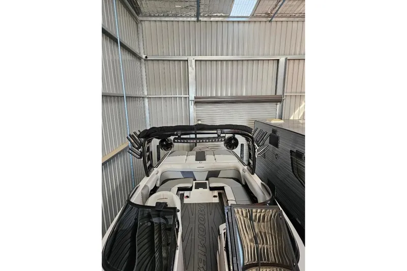 Slide: The Image of 2015 Moomba Mondo boat in storage, featuring sleek interior and modern design. - 7