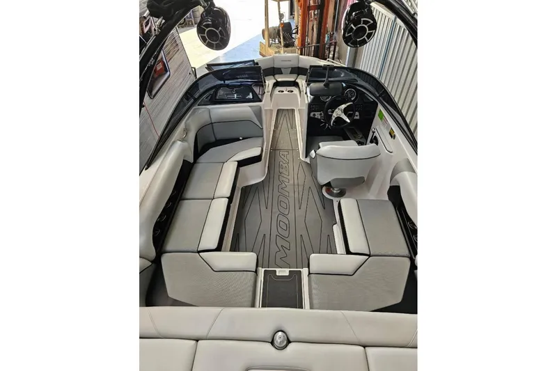 Slide: The Image of 2015 Moomba Mondo boat interior with gray seating and modern dashboard. - 8