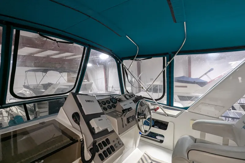 Slide: The Image of Interior view of 1996 Carver 355 Aft Cabin Motor Yacht cockpit with steering wheel and controls. - 10