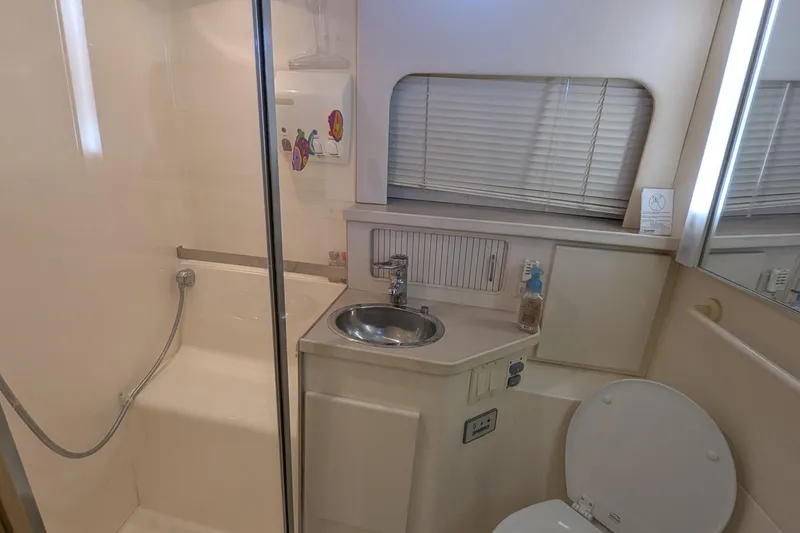 Slide: The Image of Bathroom of 1996 Carver 355 Aft Cabin Motor Yacht with shower, sink, and toilet. - 16