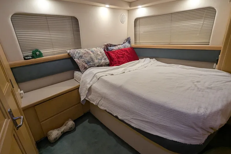 Slide: The Image of Cozy bedroom in 1996 Carver 355 Aft Cabin Motor Yacht with plush bedding and ambient lighting. - 17