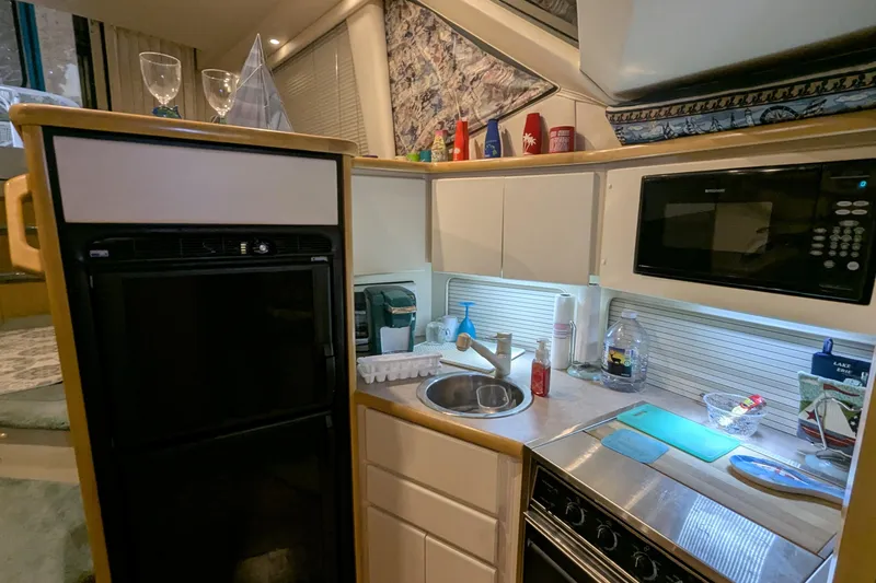 Slide: The Image of 1996 Carver 355 Aft Cabin Motor Yacht kitchen with appliances and countertop essentials. - 21