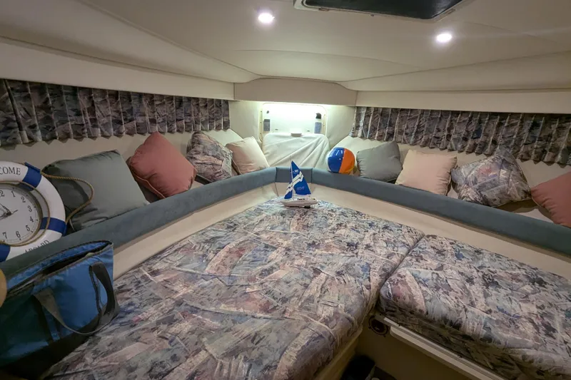 Slide: The Image of Cozy interior of 1996 Carver 355 Aft Cabin Motor Yacht with patterned bedding and cushions. - 23