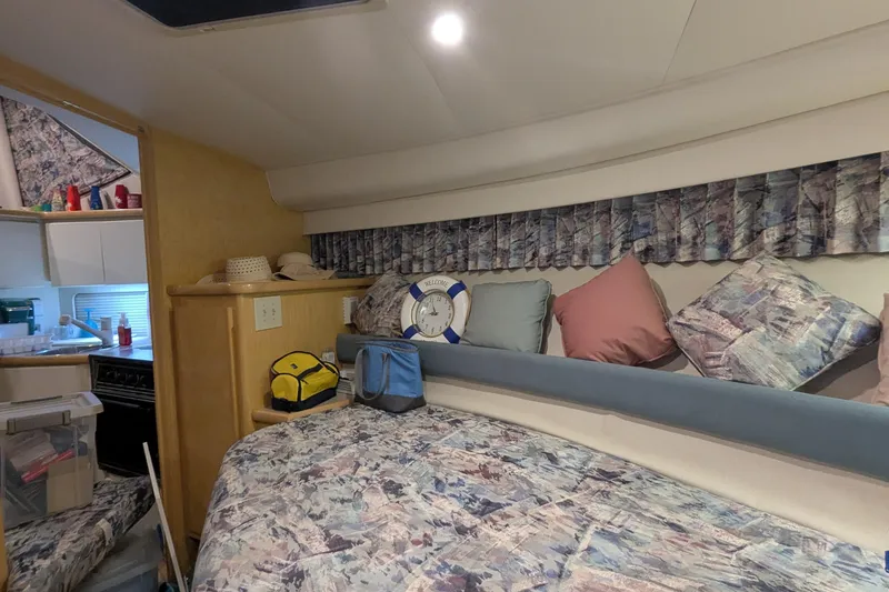 Slide: The Image of 1996 Carver 355 Aft Cabin Motor Yacht interior with cozy bedding and nautical decor. - 24