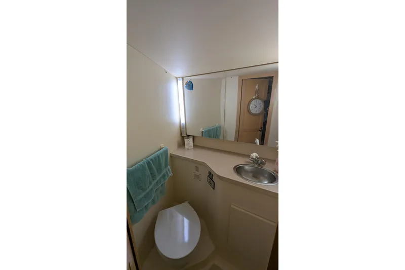 Slide: The Image of Bathroom interior of 1996 Carver 355 Aft Cabin Motor Yacht, featuring sink and mirror. - 25