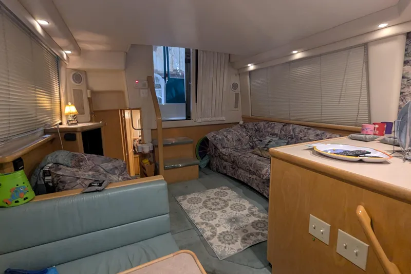 Slide: The Image of Interior of 1996 Carver 355 Aft Cabin Motor Yacht, featuring cozy seating and modern amenities. - 26