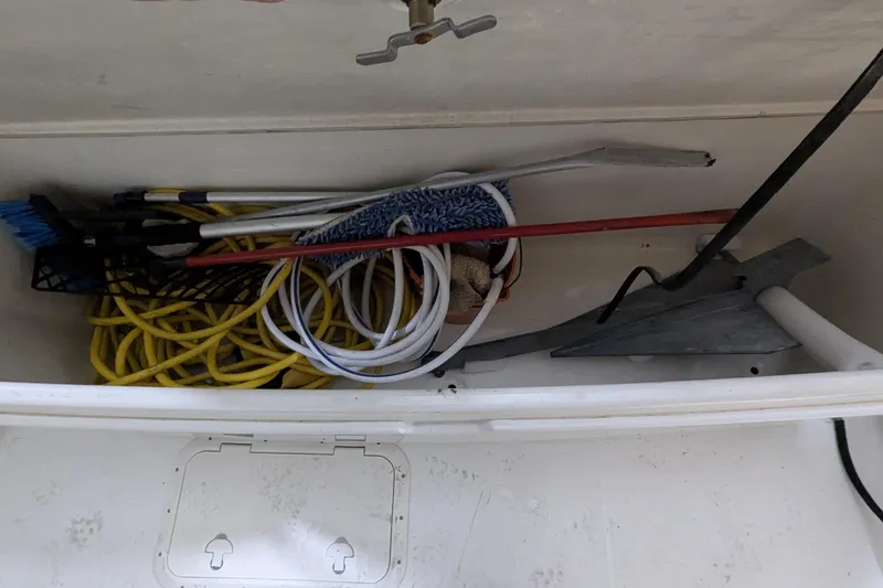Slide: The Image of Storage compartment on 1996 Carver 355 Aft Cabin Motor Yacht with ropes and cleaning tools. - 27