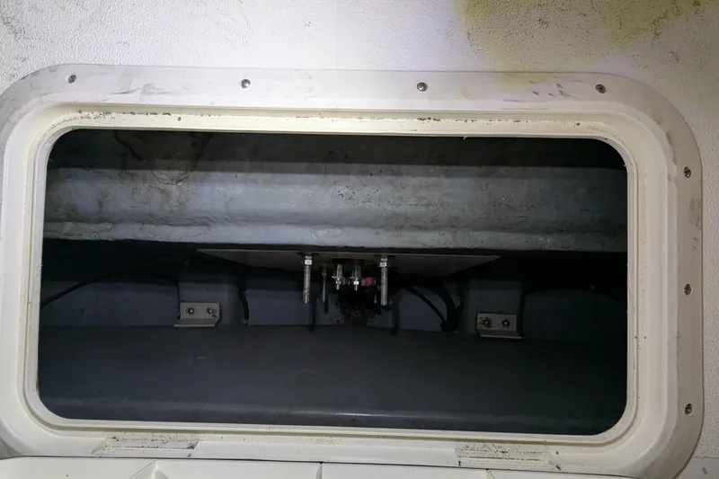 Slide: The Image of 1996 Carver 355 Aft Cabin Motor Yacht interior compartment with visible wiring and fixtures. - 28