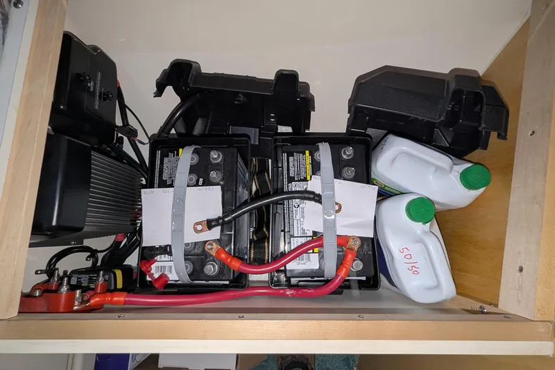 Slide: The Image of Battery compartment of a 1996 Carver 355 Aft Cabin Motor Yacht with cables and containers. - 44