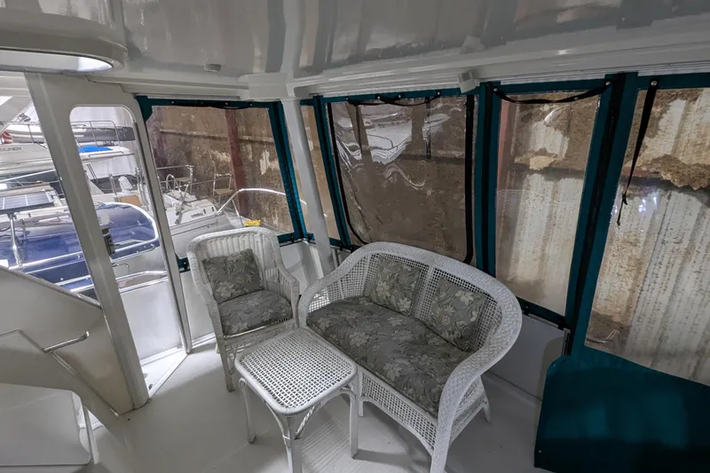 Slide: The Image of 1996 Carver 355 Aft Cabin Motor Yacht interior with wicker seating and large windows. - 6