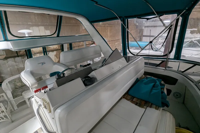 Slide: The Image of 1996 Carver 355 Aft Cabin Motor Yacht interior with helm and seating area. - 9