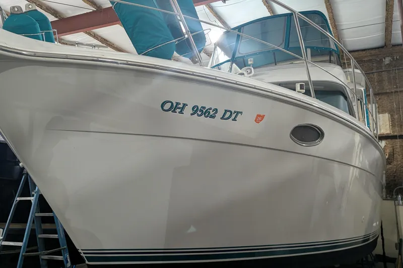 The Image of 1996 Carver 355 Aft Cabin Motor Yacht in storage, showing registration number OH 9562 DT. - 0
