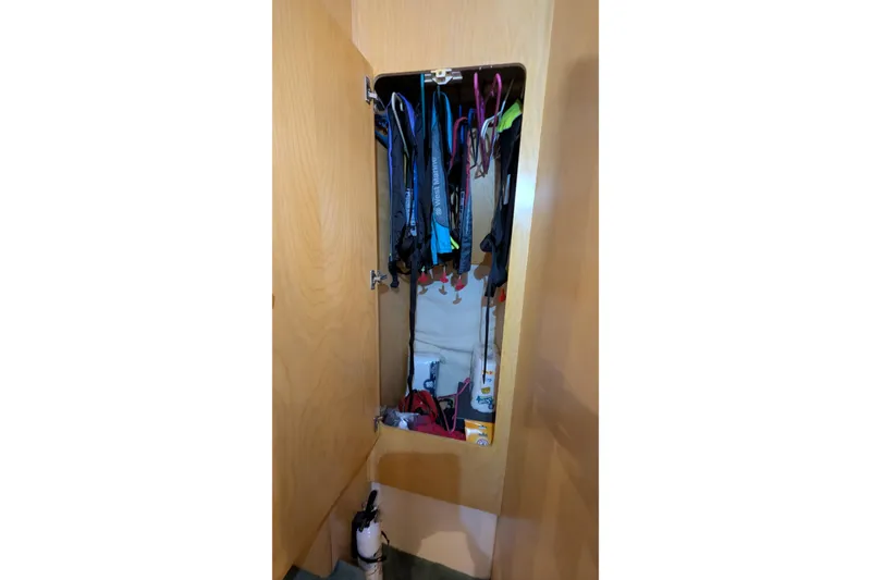 Slide: The Image of Storage cabinet inside 1996 Carver 355 Aft Cabin Motor Yacht with hanging items. - 19