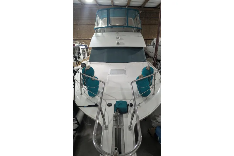 Slide: The Image of 1996 Carver 355 Aft Cabin Motor Yacht in storage, featuring teal accents. - 2