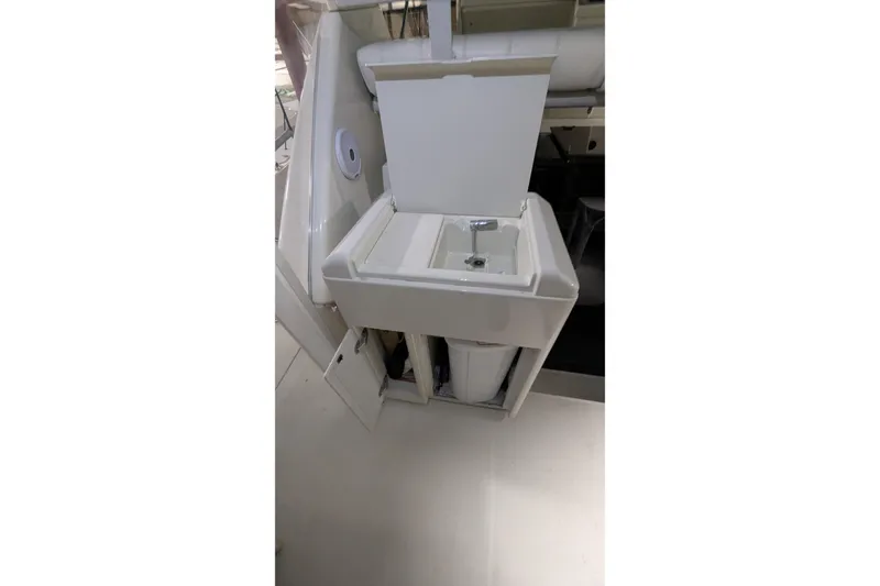 Slide: The Image of 1996 Carver 355 Aft Cabin Motor Yacht sink area with storage compartments. - 5