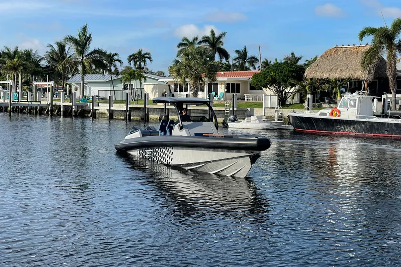 Slide: The Image of 2023 Skipper-BSK BSK 38 boat on calm water near a tropical dock. - 10