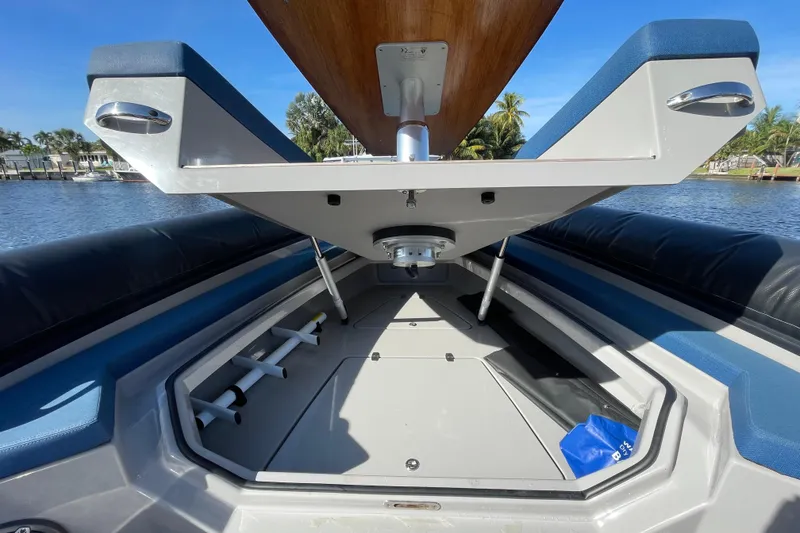 Slide: The Image of 2023 Skipper-BSK BSK 38 boat interior with open storage compartment, blue and gray seating. - 15