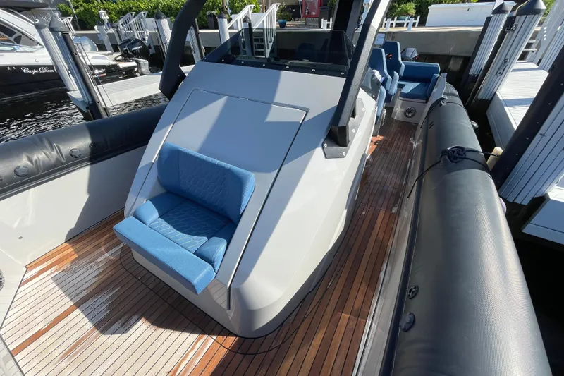 Slide: The Image of 2023 Skipper-BSK BSK 38 boat with sleek design and blue seating on wooden deck. - 20