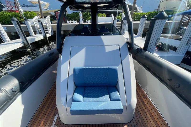 Slide: The Image of 2023 Skipper-BSK BSK 38 boat with blue seating, docked at a marina. - 21