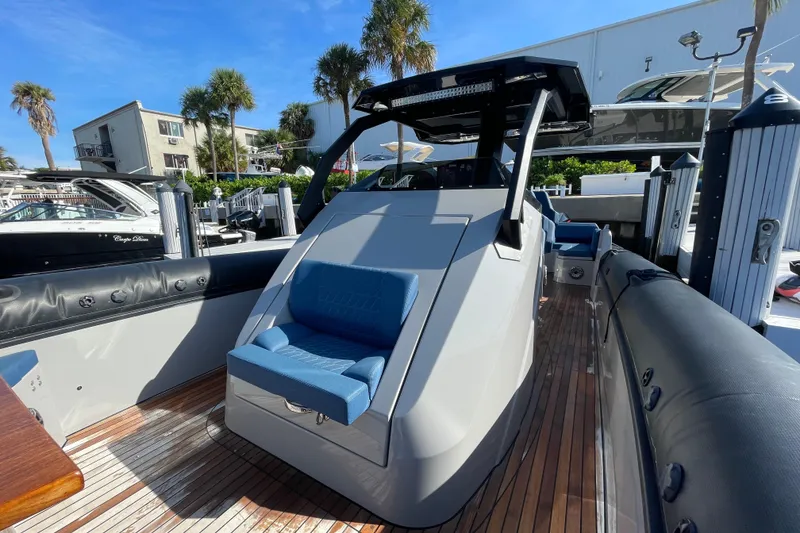 Slide: The Image of 2023 Skipper-BSK BSK 38 boat with sleek design, docked under clear blue sky. - 23